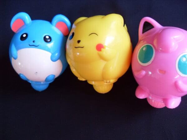 Marill, Pikachu, and Jigglypuff spinning top toys, front view.