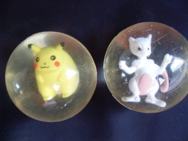 Pikachu and Mewtwo rubber bouncy ball toys, front view.