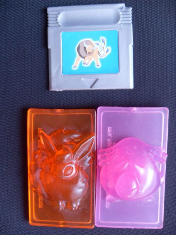 Chansey and Flareon plastic carvings.
