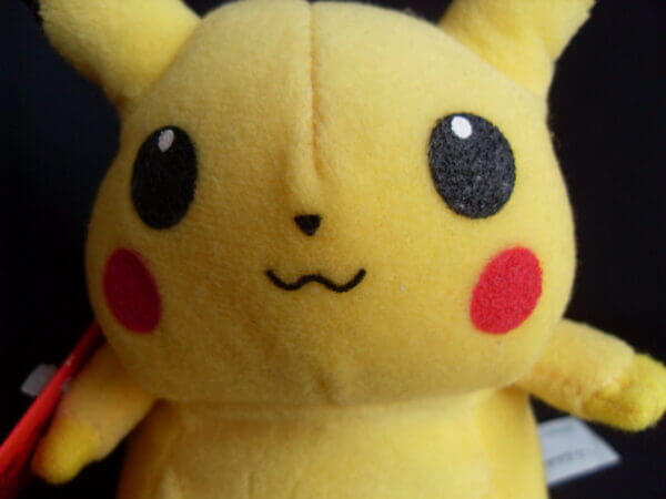 1999 Pokemon plush toy Pikachu, face close-up.