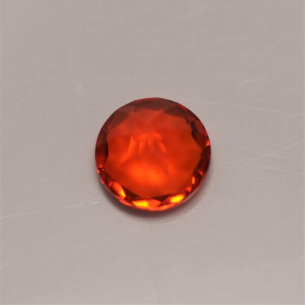 Mexican Fire Opal, 7mm round cut, bottom view.