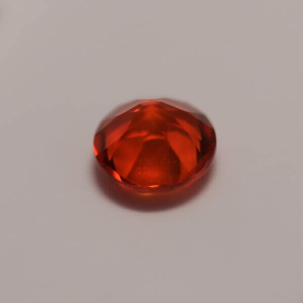 Mexican Fire Opal, 7mm round cut, side view.