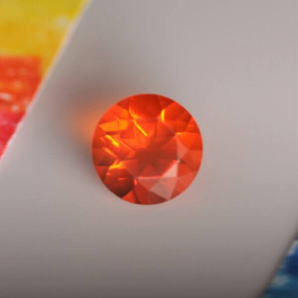 Mexican Fire Opal, 7mm round cut, front view.