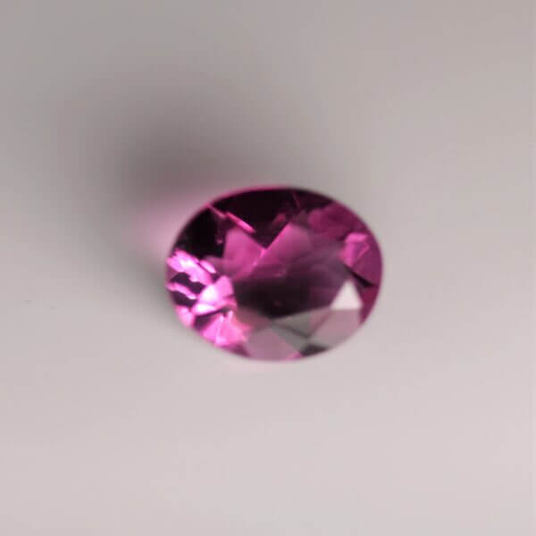 Pink Fluorite, 10x8mm oval cut, front view.