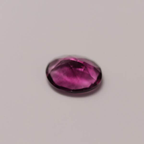 Pink Fluorite, 10x8mm oval cut, side view.