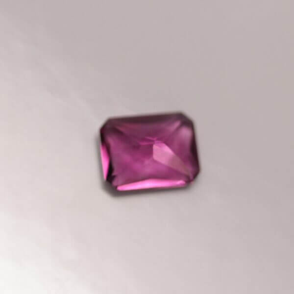 Pink Fluorite, 8x6mm octagon cut, bottom view.