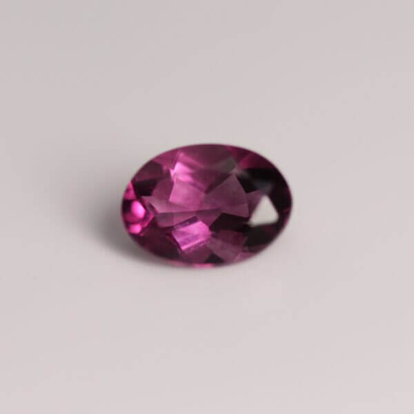 Pink Fluorite, 7x5mm oval cut, front view.