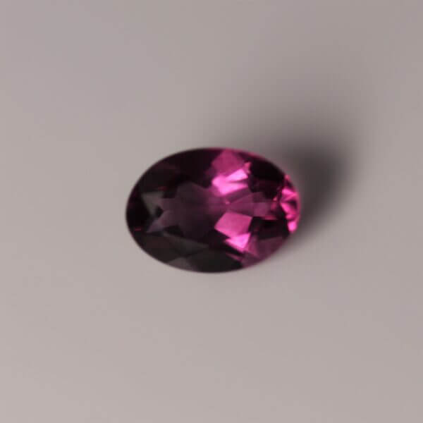 Pink Fluorite, 7x5mm oval cut, top view.
