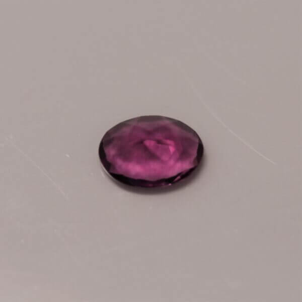 Pink Fluorite, 7x5mm oval cut, side view.