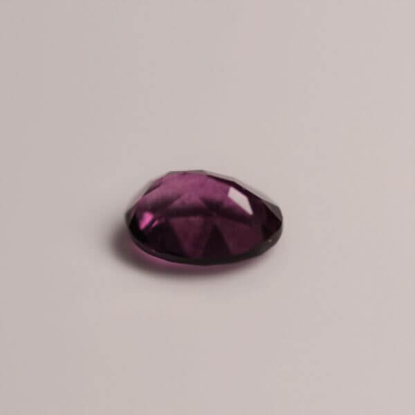 Pink Fluorite, 7x5mm oval cut, bottom view.