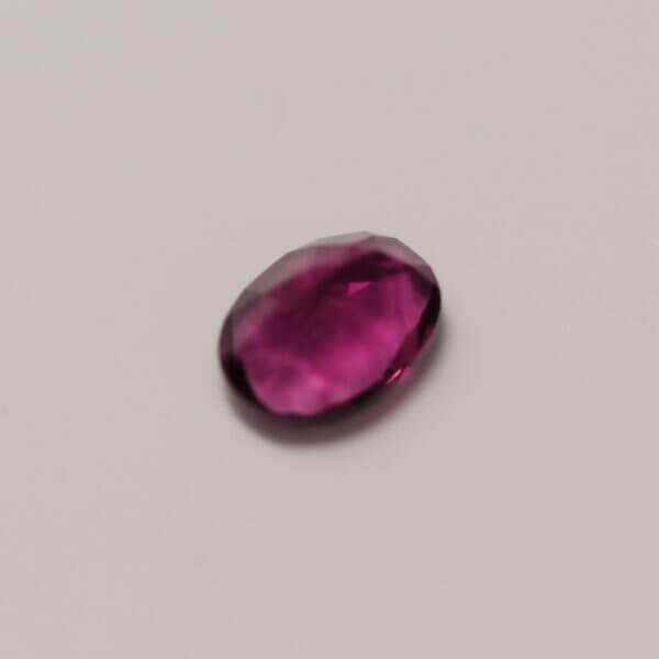 Pink Fluorite, 8x6mm oval cut, bottom view.