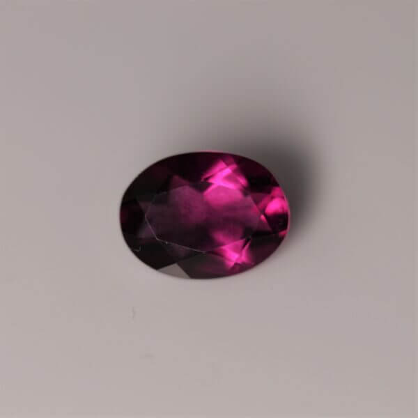 Pink Fluorite, 8x6mm oval cut, front view.
