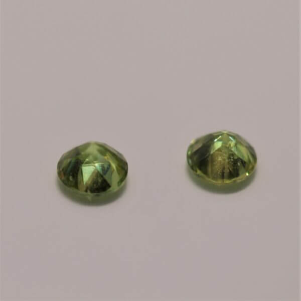 Green Sphene, 5mm round matched pair, side view.
