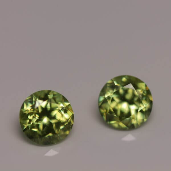 Green Sphene, 5mm round matched pair, front view.