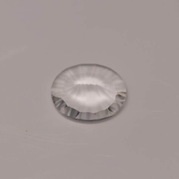 Petalite, 10x8mm quantum cut oval, side view.