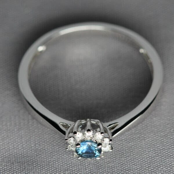 14kt White Gold, Diamond, and Blue Montana Sapphire flower ring, side view.