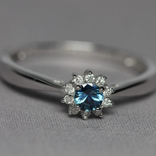 14kt White Gold, Diamond, and Blue Montana Sapphire flower ring, front view.
