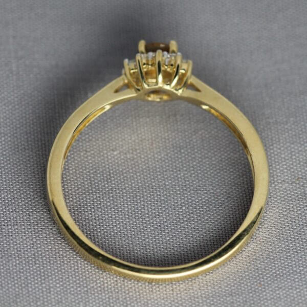 14kt Yellow Gold, Diamond, and Orange Montana Sapphire flower ring, side view.