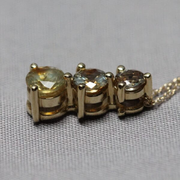 14kt Yellow Gold and 3 stone Kaleidoscope Montana Sapphire pendant, side view.