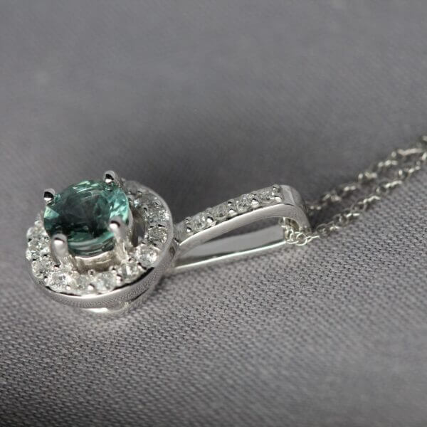 14kt White Gold, Diamond, and Green Montana Sapphire halo pendant, side view.