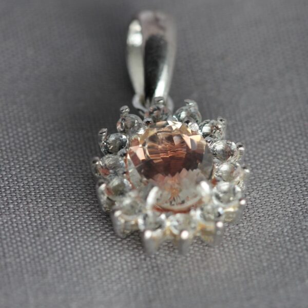 Sterling Silver, White Topaz, and Oregon Sunstone pendant, side view.