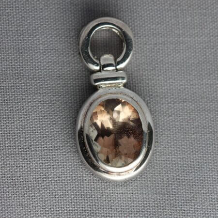 Sterling Silver 9x7mm Bezel set Oregon Sunstone pendant, front view.
