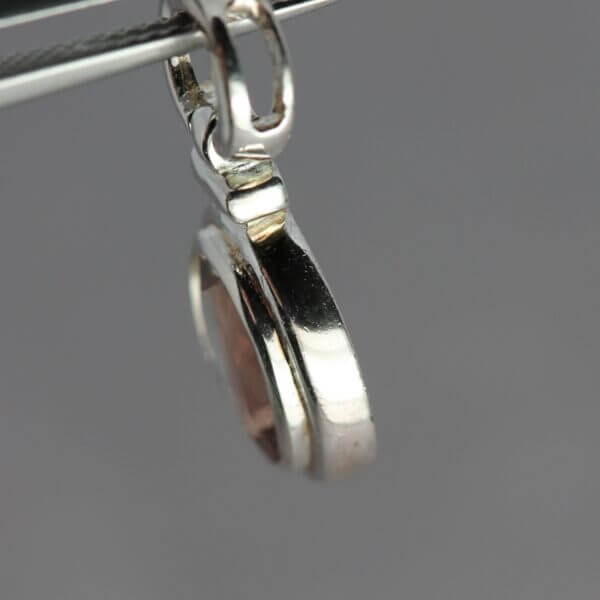 Sterling Silver 9x7mm Bezel set Oregon Sunstone pendant, side view.