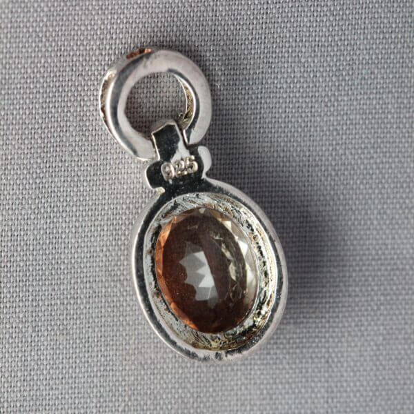 Sterling Silver 9x7mm Bezel set Oregon Sunstone pendant, back view.