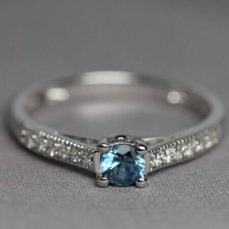 14kt White Gold, Diamond, and Blue Montana Sapphire solitaire ring, front view.