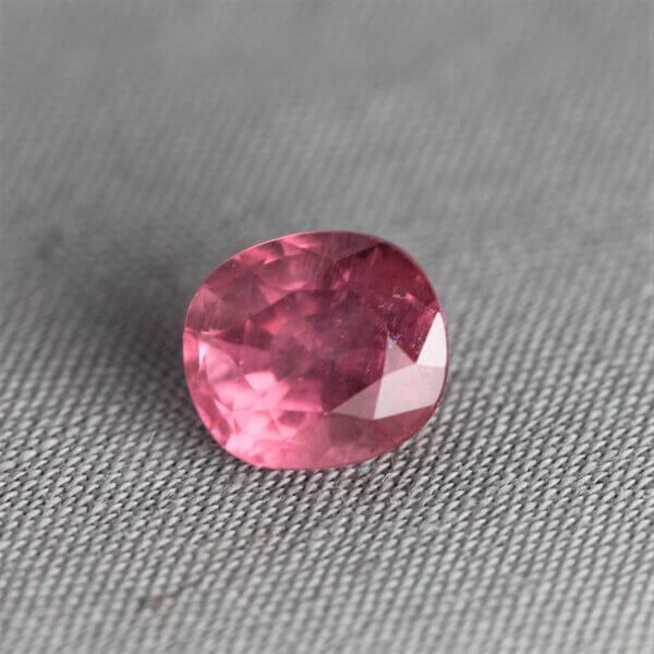 Mahenge Spinel, 7x6mm rounded oval cut, front view.