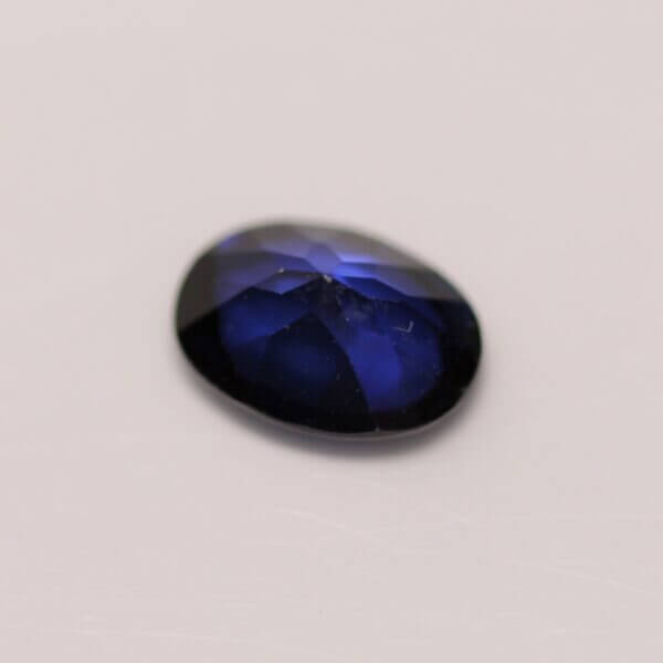 Synthetic Sapphire, 7x5mm oval cut, back view.