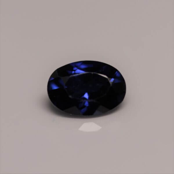 Synthetic Sapphire, 7x5mm oval cut, front view.