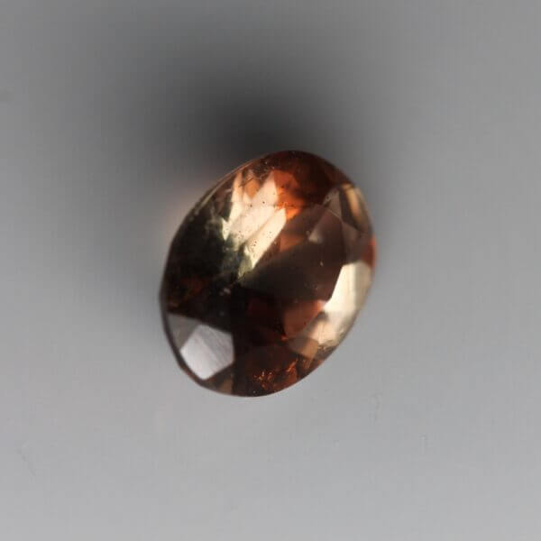 Andalusite, 8x6mm oval cut, side view.