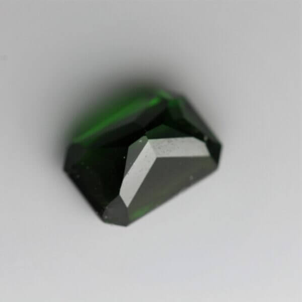 Chrome Diopside, 7x5mm octagon cut, back view.