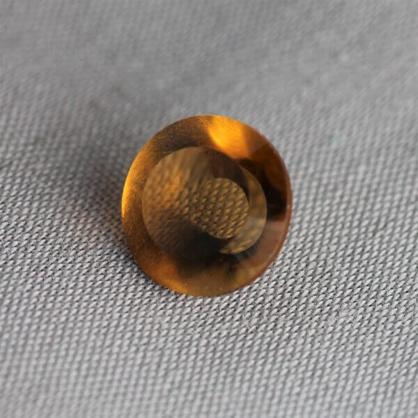 Madeira Citrine, 8mm concentric cut, side view.
