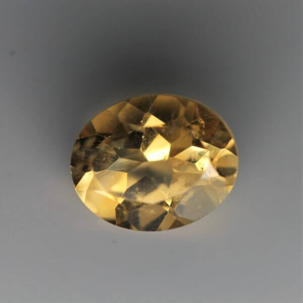 Citrine, 9x7mm oval cut, front view.