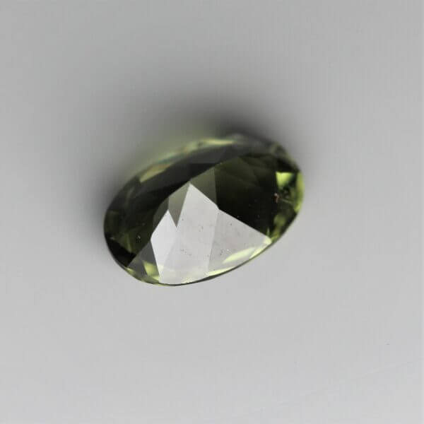 Diopside, 6x4mm oval cut, back view.