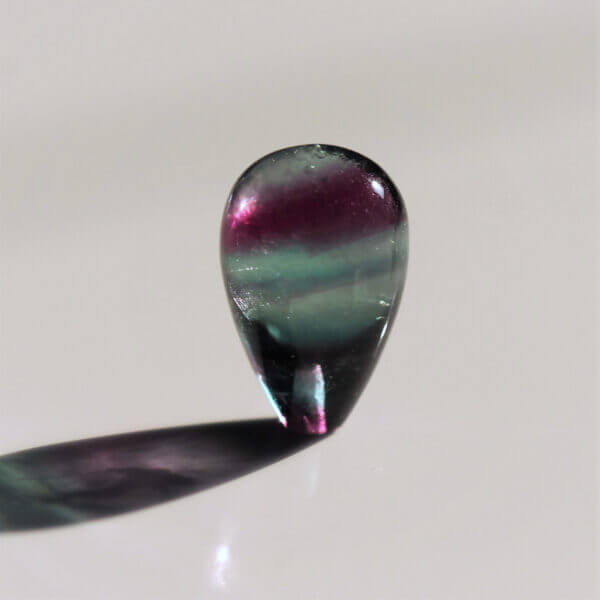 Fluorite, 15x10mm briolette bead, without ring, side view.