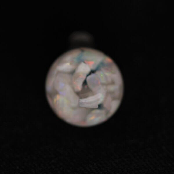 Opal suspended in a 8mm round globe, side view.
