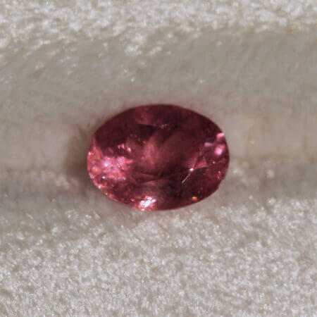 Sweet Home Rhodochrosite, 8x6mm oval cut, front view.