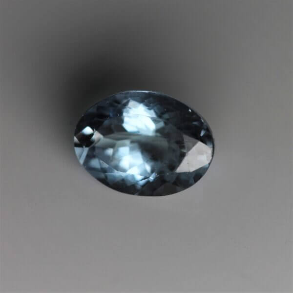 Zoisite, 8x6mm oval cut, front view.